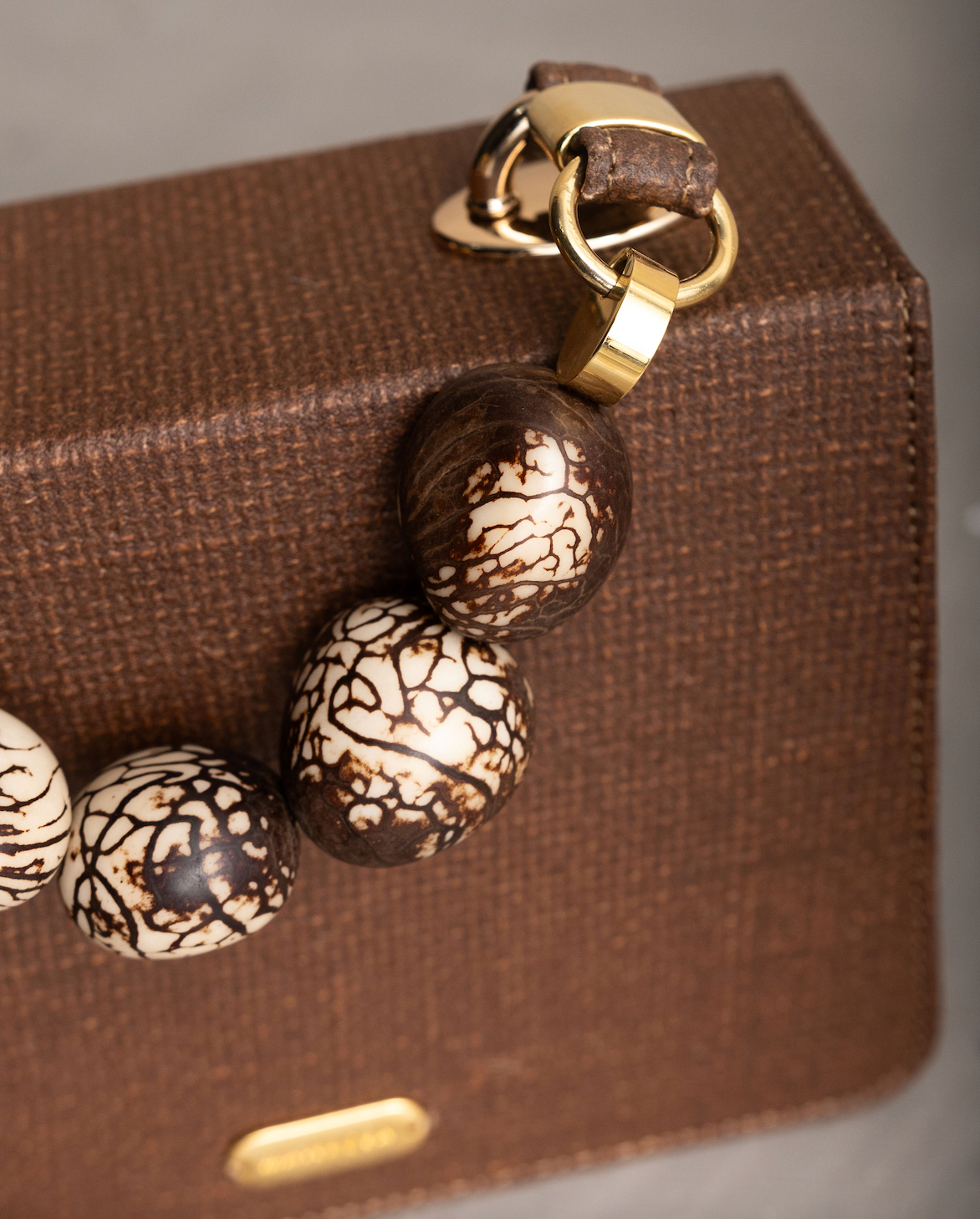 LOMARA PURSE WITH TAGUA SEEDS HANDLE